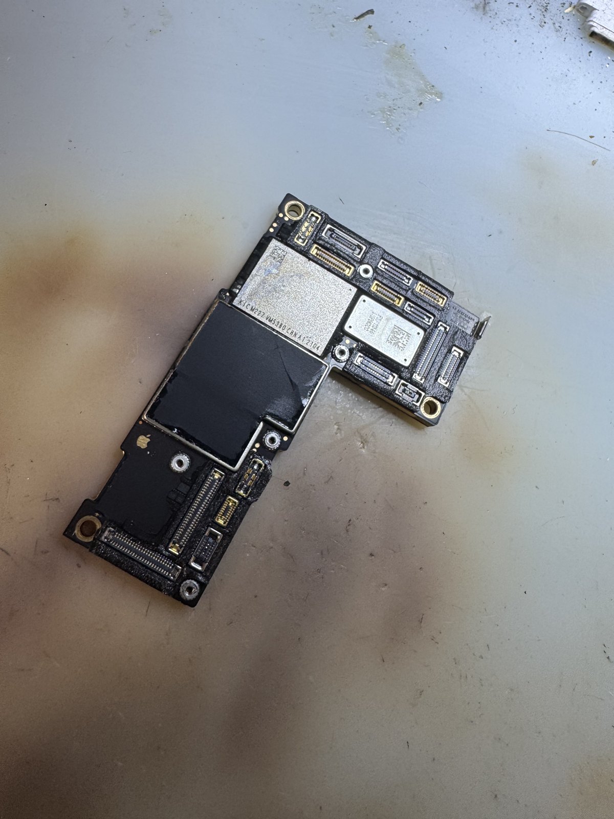 水没したiPhone 12 Pro Maxの基板全体。広範囲に水没痕と変色が見られる